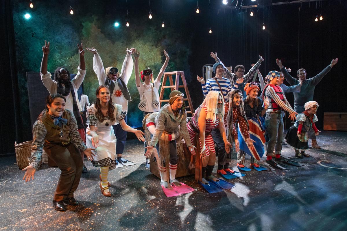 Peter and the Star Catcher Theatrical Production featuring a group of students in costumes performing.