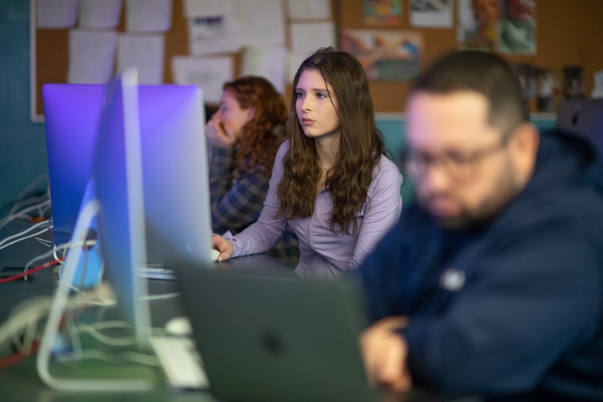 Dower Computer Studio with three students in front of computers.