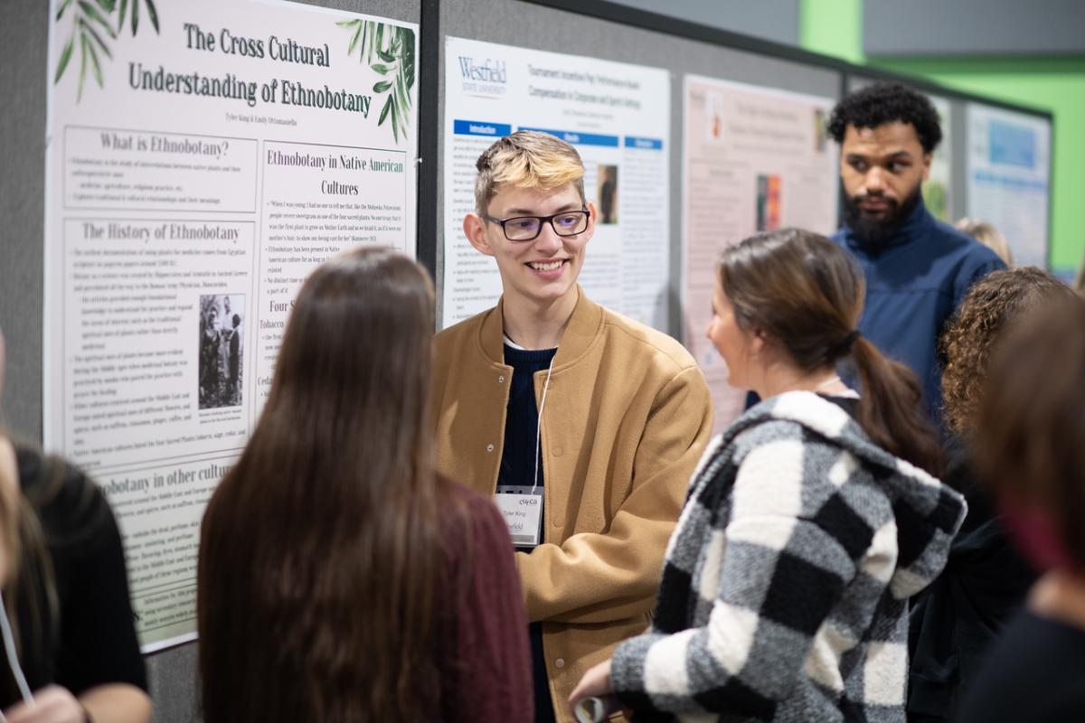 Student giving a cultural presentation at an undergraduate research conference.