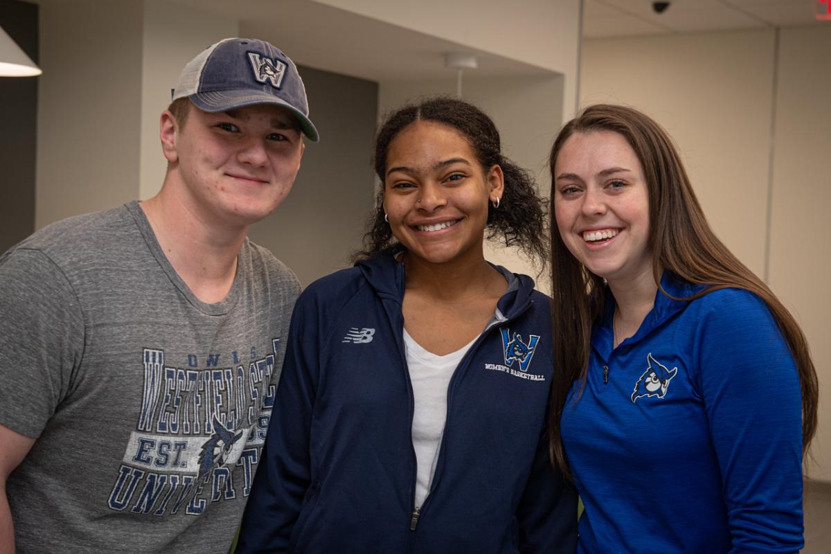 Three students smiling wearing WSU shirts.
