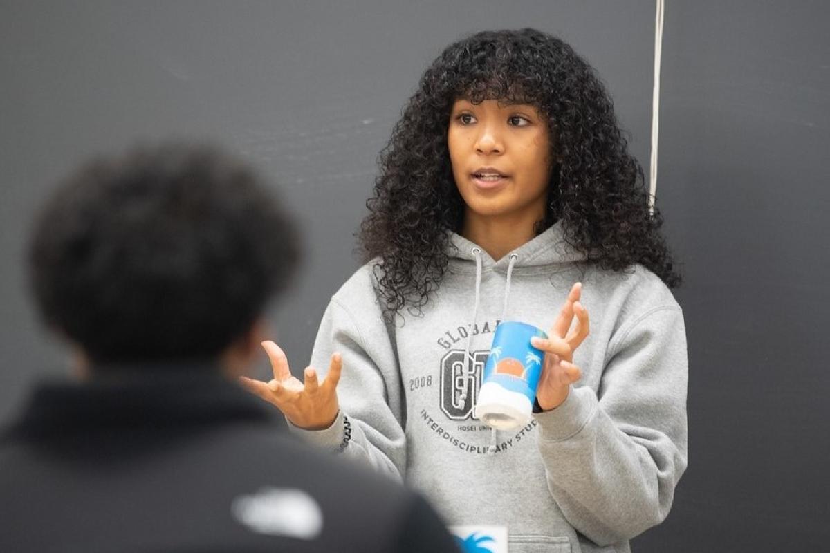 Student presenting in a management classroom.
