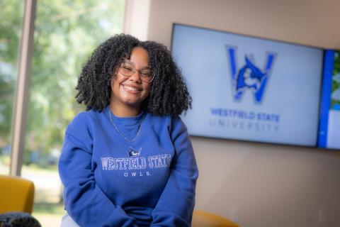 Dianyeliz Ozuna Sandoval, president of the Class of 2026. She's wearing a blue sweatshirt and poses in front of a white wall.
