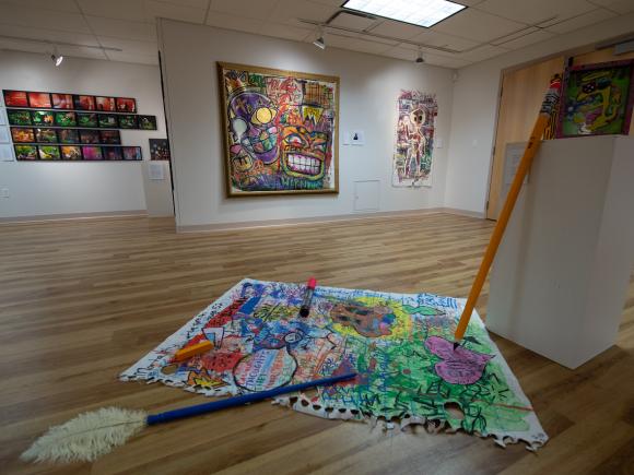 Something Extraordinary Art Exhibit February 2023 featuring colorful art work on the walls and floor of the Arnos Maris Art Gallery.