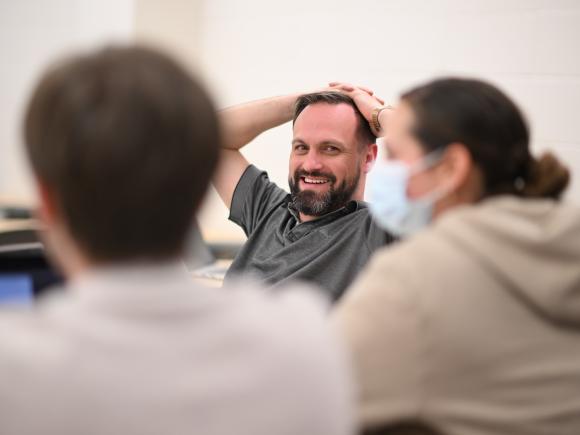 Psychology graduate student in classroom smiling.