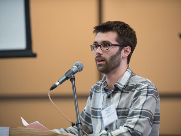 English student speaking at a podium.