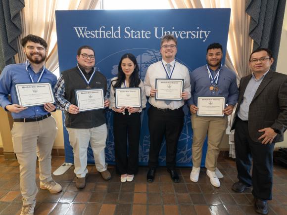 Finance students smiling together at an academic awards ceremony.