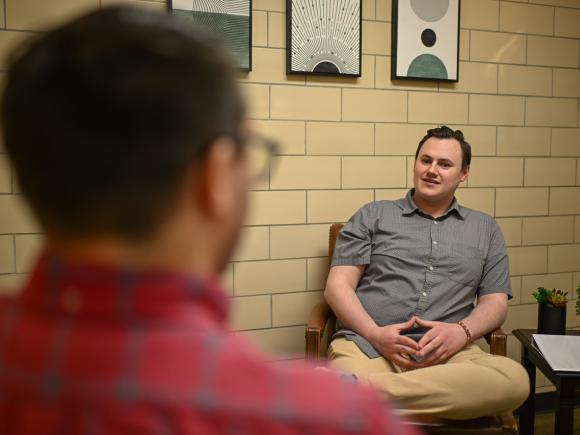 Student and faculty member having a conversation.