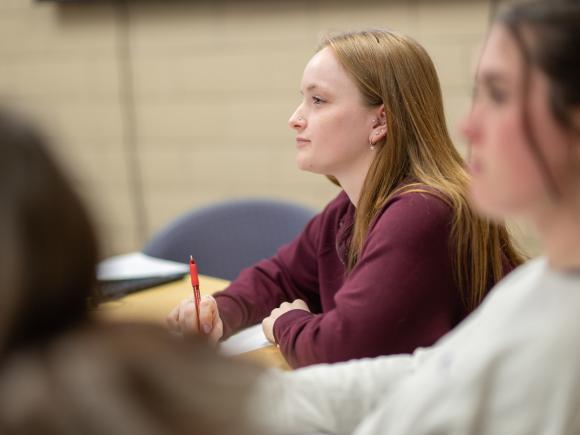 Student listening attentively during a classroom lecture.