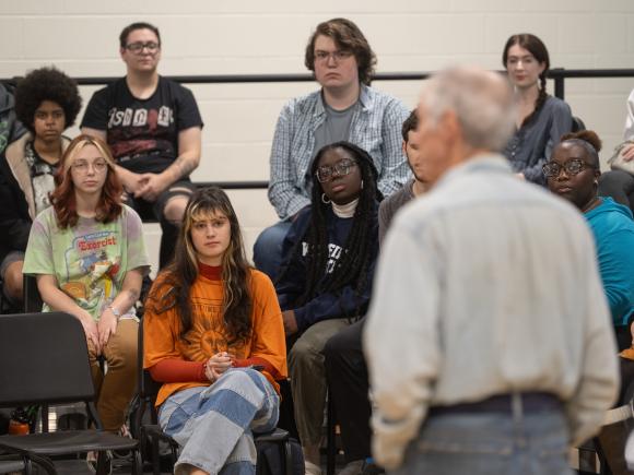 Music students in a classroom listening to a lecture.