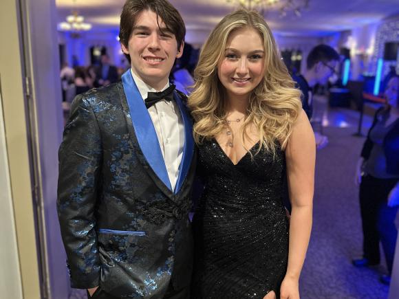 Students in formal dress look at camera