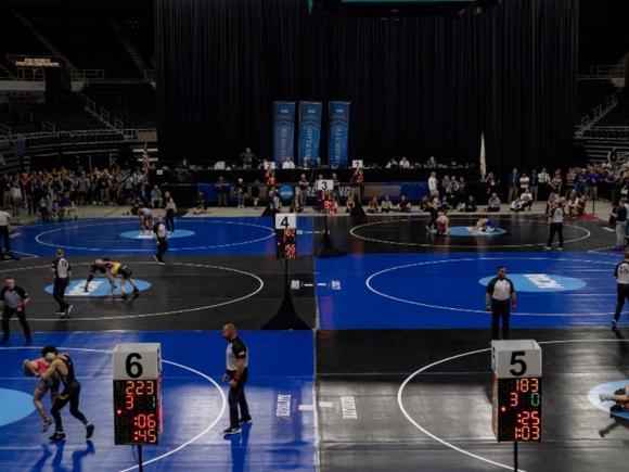 Wrestling Arena set up with multiple competition areas and officials