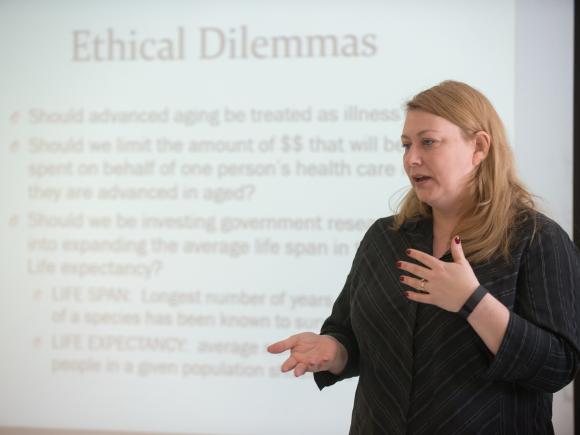 Sociology faculty member giving a presentation in front of a classroom.