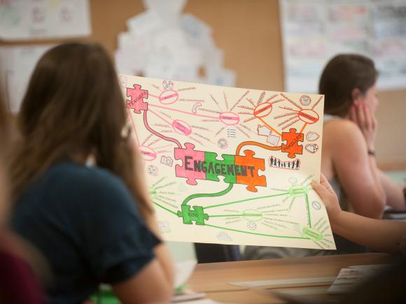 Education student holding up a classroom project.