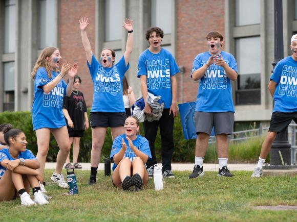 Students clap and cheer while wearing Westfield State blue t-shirts