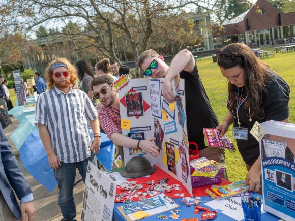 History Club Students talk to others at table