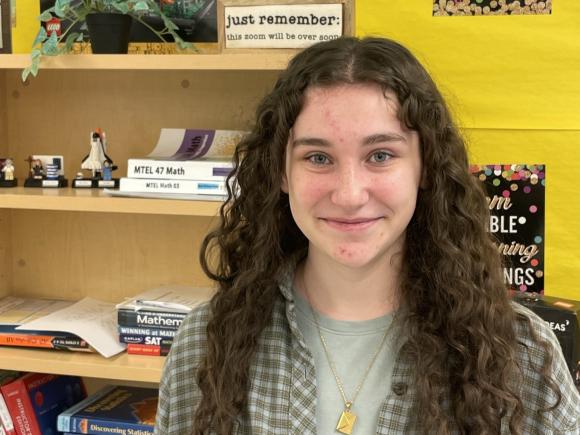 Math tutor smiling in the Math Tutoring Center.