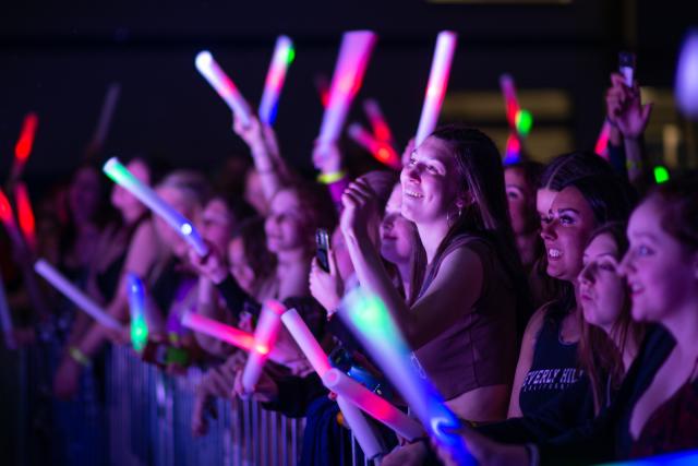 Spring Weekend Concert Group of Students Smiling with Glow Sticks