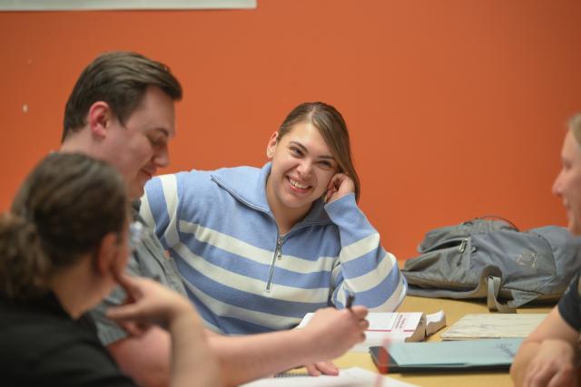 Student working on a classroom project with two other students.