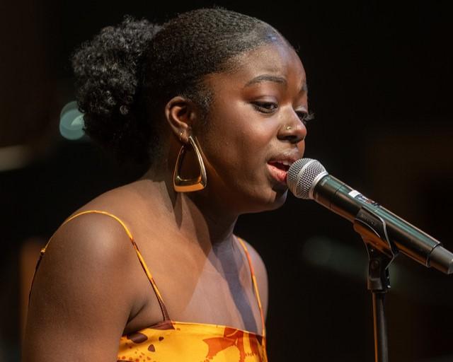 Student vocalist performing on stage at the university’s Jazz Night event.