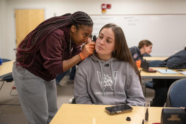 Students in the Medical Aspects of Physical Activity class learn to use an otoscope and opthalmoscope. 