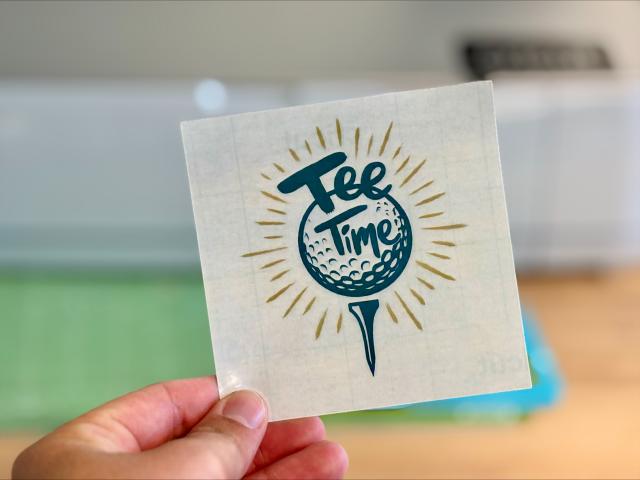 sticker labeled "tee time'; a green and yellow logo with a golf ball on a tee