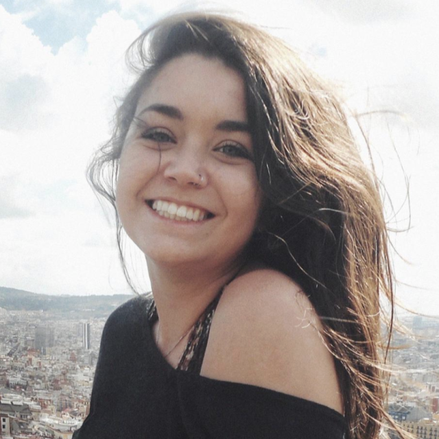 Art alum Allison smiling with an Italian cityscape in the background.