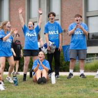 Students clap and cheer while wearing Westfield State blue t-shirts